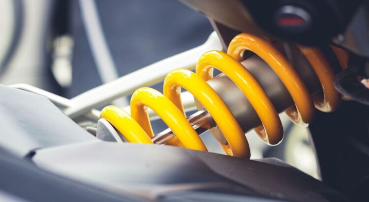 Close-up of a bright yellow motorcycle coil spring and shock