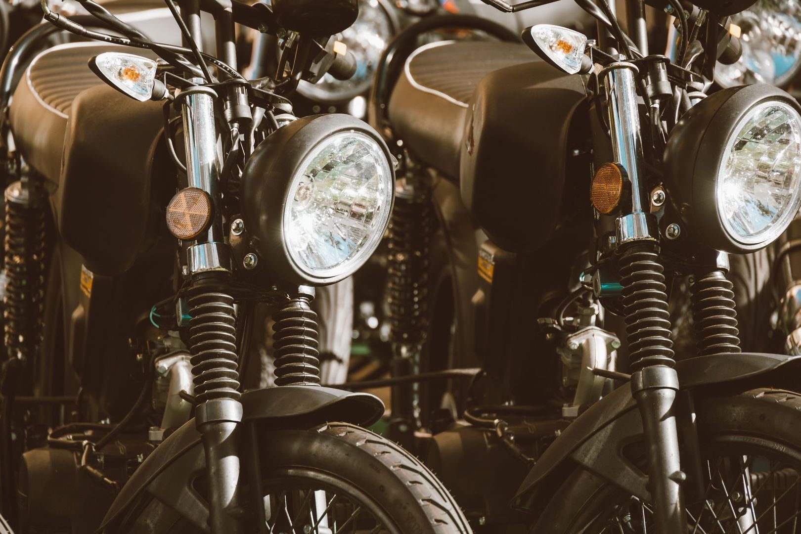 Close-up of two motorcycles showing front forks and suspension